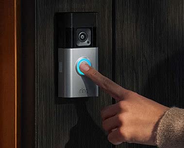 A person's finger presses Amazon's Ring Battery Doorbell Pro