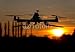 Produktbild Poster-Bild 40 x 30 cm: "Hexacopter drone flying in the sunset", Bild auf Poster
