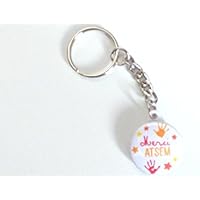 un porte clé, bijou de sac badge argenté "ATSEM " 25mm