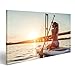 Produktbild islandburner Bild auf Leinwand Frau auf Stand up Paddle Board. Spaß beim SUP-Board während des Sonnenuntergangs. Aktiver Lebensstil. Wandbild, Poster, Leinwandbild GJF