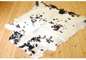 Cowhide Rug - white with small black patches. 210 by 185 cm.