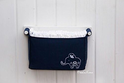 Nautical nursery organizer in kids room with a fabric pocket in navy blue, with cute nursery animal elephant