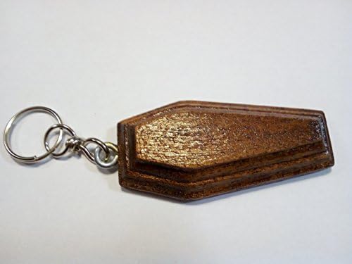 Coffin-shape dark walnut-colored wooden keychain. Coffins like talisman, amulet.