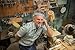 Produktbild Alu-Dibond-Bild 140 x 90 cm: "The man leaned his elbow on the wood lathe in workshop.", Bild auf Alu-Dibond