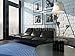 Produktbild Alu-Dibond-Bild 110 x 80 cm: "Living room interior with black leather couch against brick wall", Bild auf Alu-Dibond