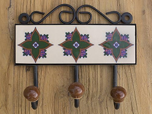 Three metal hooks with ceramic tile.Traditional Indian design.