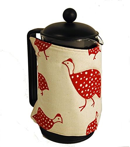 Cafetiere cosy, with red guinea fowl designs on a milky white background.