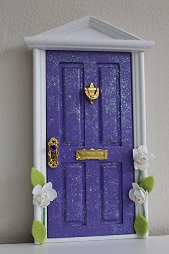 Purple magical fairy door with climbing flowers and fairy dust / key