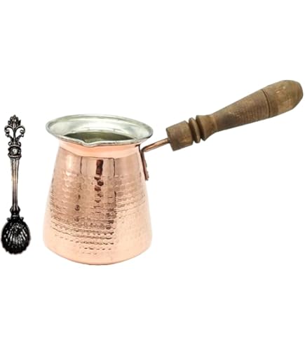 This is a traditional Turkish coffee pot, also known as a cezve. It's made of copper with a brass handle and likely has an interior plating for safety. The design features a
