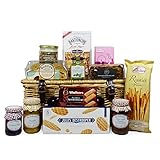 Deliciosos platos favoritos de la comida, presentados en una cesta de mimbre tradicional para hacer una cesta de regalo de lujo.