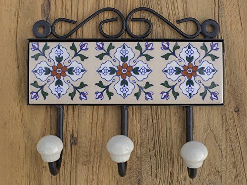 Three metal hooks with ceramic tile.Traditional Indian design.