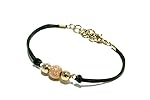 Bracciale cordino nero con centrale sfere in metallo colore oro e oro rosa.