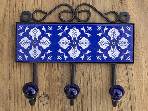 Three metal hooks with ceramic tile.Traditional Indian design.