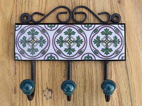 Three metal hooks with ceramic tile.Traditional Indian design.