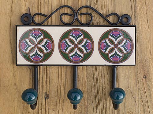 Three metal hooks with ceramic tile.Traditional Indian design.