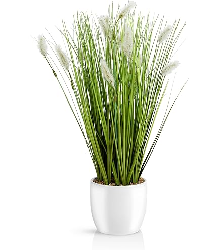 Kunstmatige bamboeplant in schaal met decoratieve stenen, bamboegras
