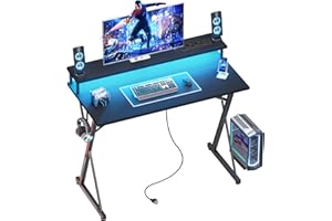 BEXEVUE Escritorio Gaming Regleta Enchufes LED - 100x50cm Escritorio Gamer Ergonómico, Grande Soporte Monitor, Mesa Moderna, Marco X, Gancho Auriculare, Estudio Juego Trabajo Dormitorio Oficina Hogar